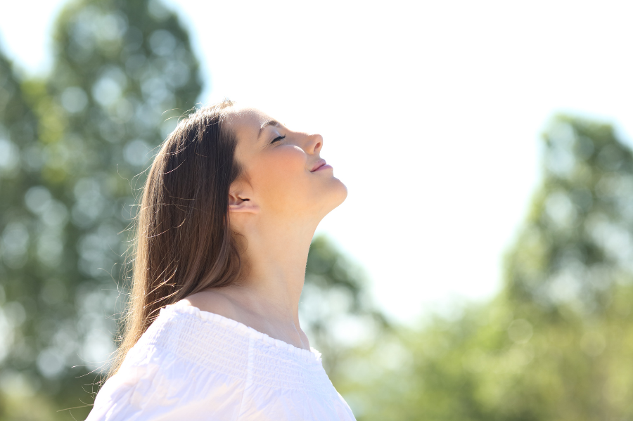 woman breathing fresh air outdoors