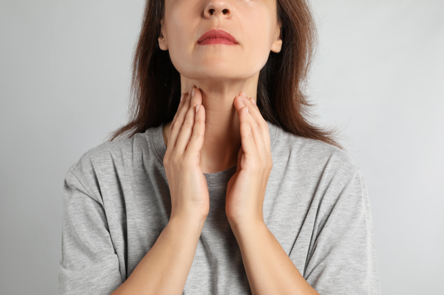 woman doing thyroid self examination