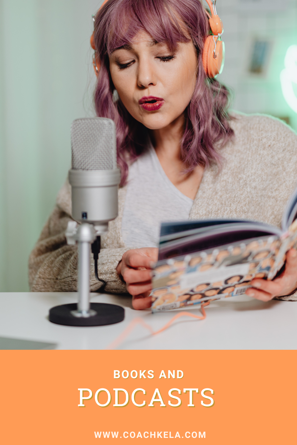 a woman holding a book while talking on a podcast microphone