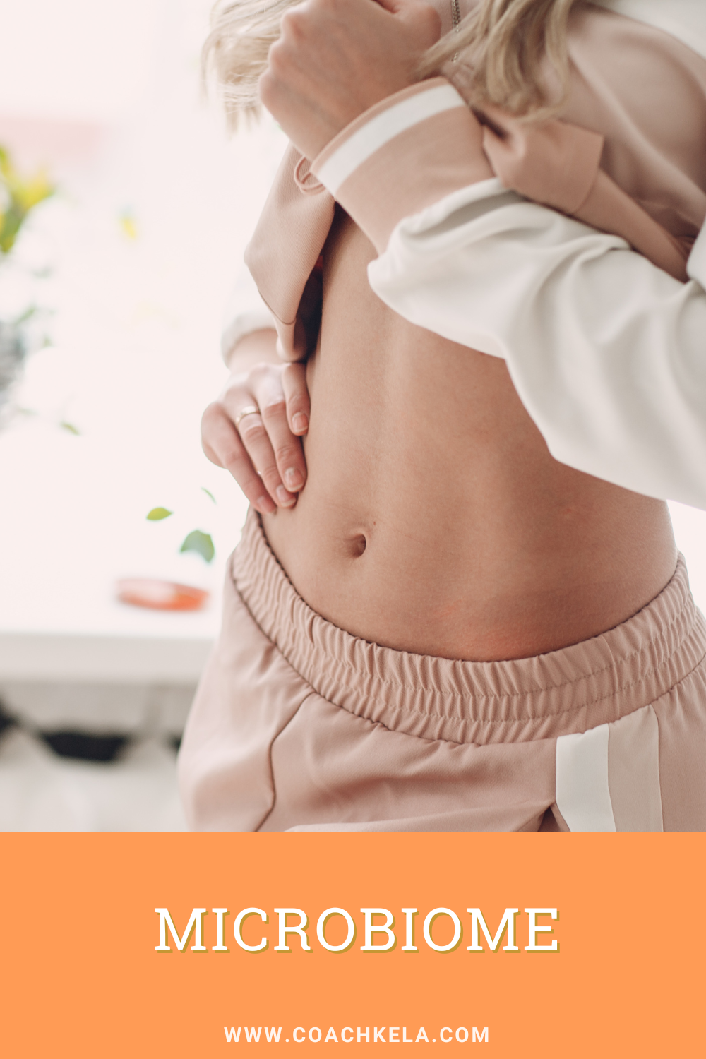 Woman in pink shorts showing her healthy gut