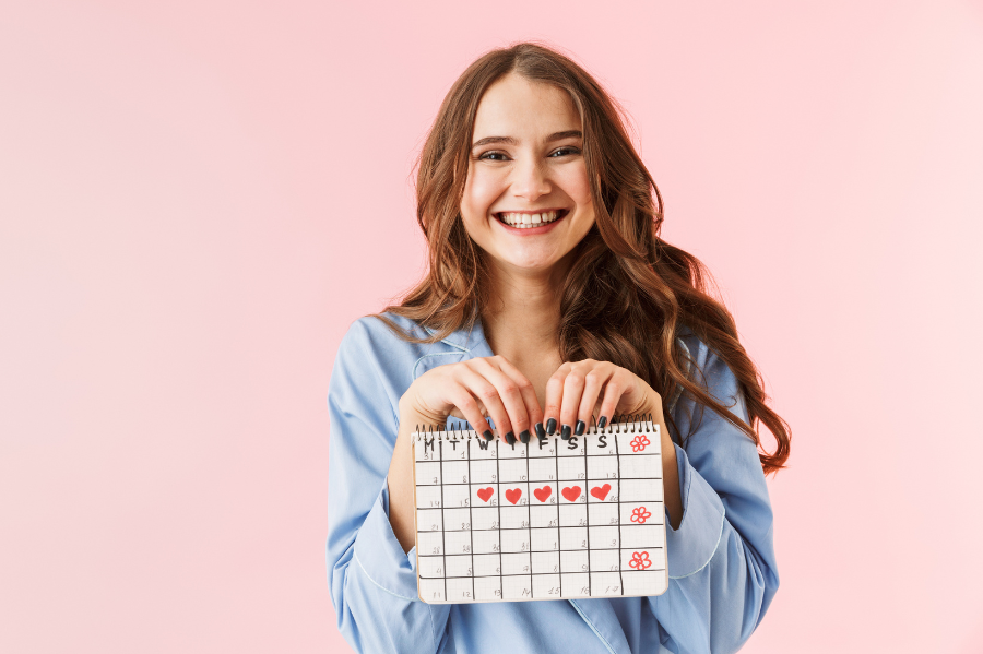 woman holding a menstrual cycle calendar