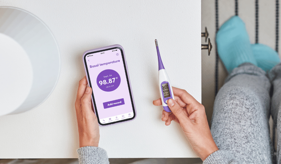 Woman tracking basal body temperature or bbt chart
